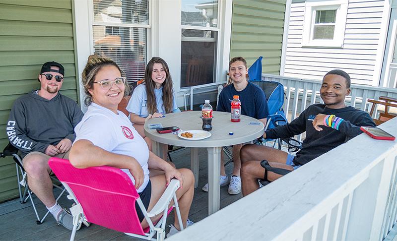 Students gathered on a porch